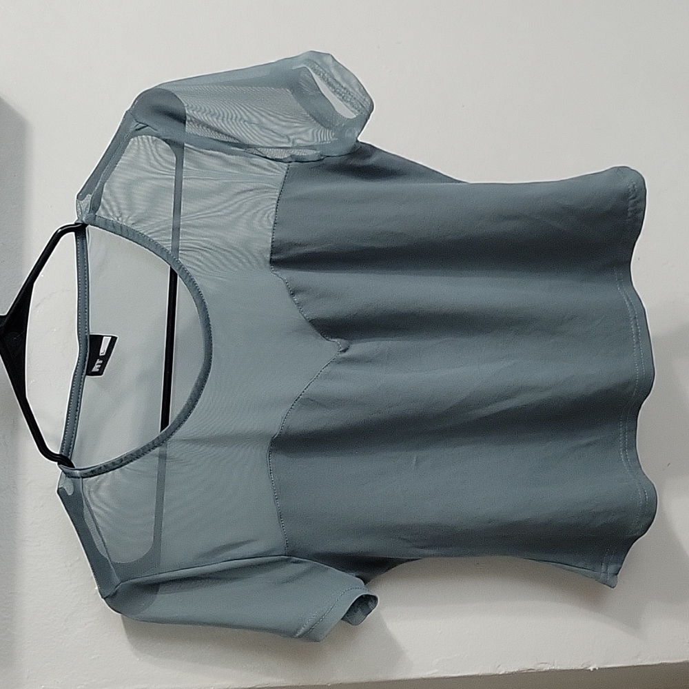 Pastel blue/green shirt with see-through back.